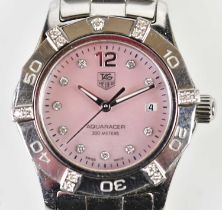 TAG HEUER; a lady's Aquaracer stainless steel wristwatch with pale pink dial, diamond set hour