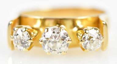 An 18ct yellow gold three stone diamond ring with unusual raised setting formed of three old