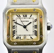 CARTIER; a Santos wristwatch with ivory coloured dial set with Roman numerals and date aperture,
