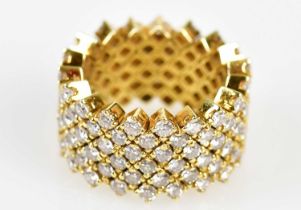 An unusual 18ct yellow gold diamond ring in the manner of Van Cleef & Arpels, the broad band