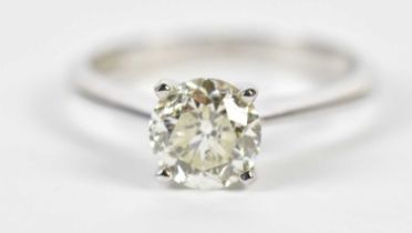 An 18ct white gold diamond solitaire ring, the four claw set round brilliant cut stone approx 1.