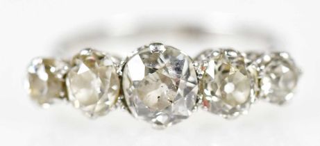 An antique white metal five stone old cut graduated diamond ring, the central stone approx 0.