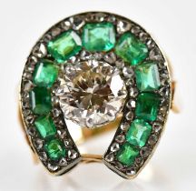 An unusual 14ct yellow gold white metal tipped diamond and emerald ring, the eight claw set raised