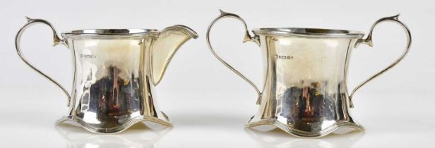 CHARLES S GREEN & CO; a George V hallmarked silver milk jug and sugar bowl, Birmingham 1928,