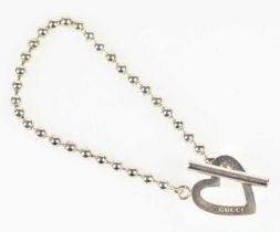 GUCCI; a hallmarked silver Boule heart bracelet, in original pouch and box.