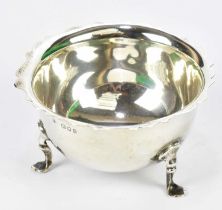 ROBERT PRINGLE & SONS; a George V hallmarked silver sugar bowl with cast scalloped rim on paw