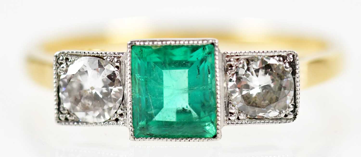 An 18ct yellow gold white metal tipped emerald and diamond Art Deco design ring with central