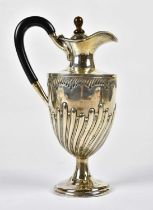 BARKER BROS; an Edward VII hallmarked silver pedestal water jug with gadrooned decoration,