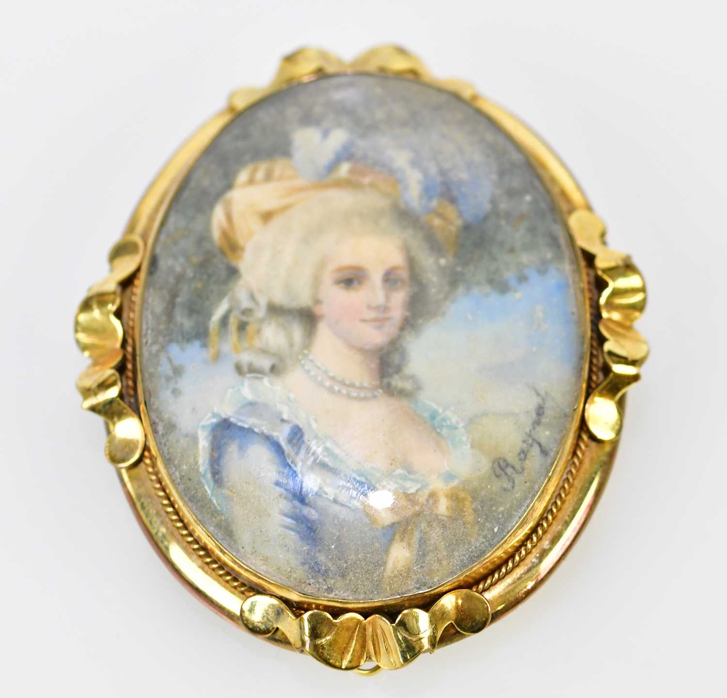 X A late 19th century yellow metal framed oval portrait miniature brooch, hand painted with the