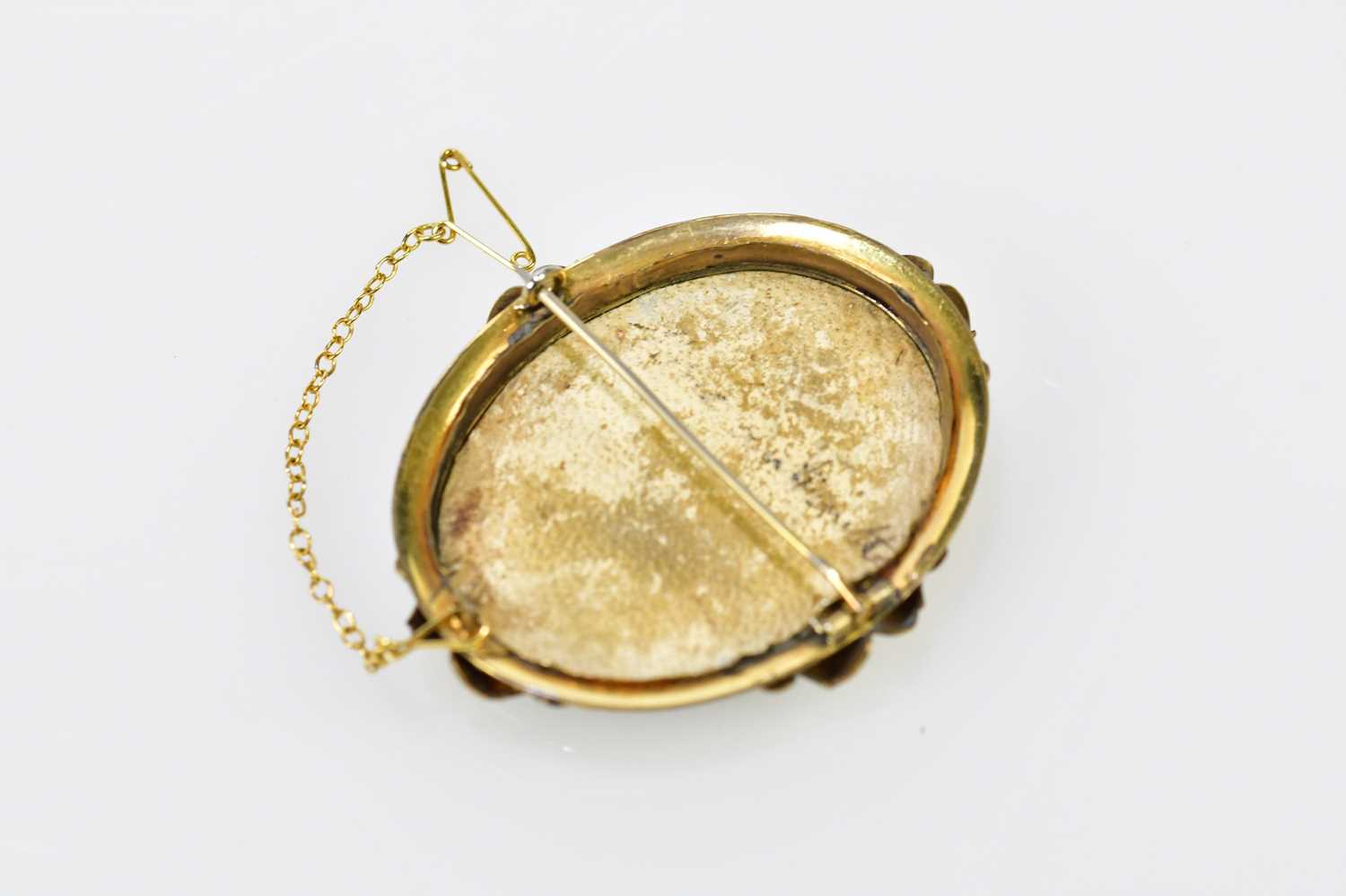 X A late 19th century yellow metal framed oval portrait miniature brooch, hand painted with the - Image 2 of 4