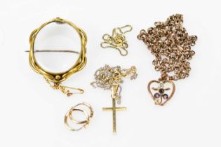 A group of 9ct gold and yellow metal jewellery including a heart shaped pendant on chain, cross