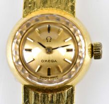 OMEGA; a lady's vintage 18ct yellow gold wristwatch with baton markers to the circular dial and with