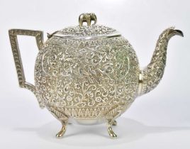 A late 19th century Indian silver kutch teapot with elephant finial above cast decoration with