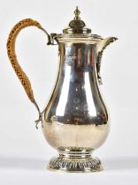 MARSTON & BAYLISS; an Edward VII hallmarked silver baluster shaped water jug with cast rim and spout