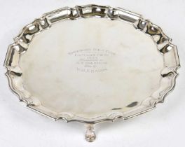 CHARLES STUART HARRIS; an Edwardian hallmarked silver salver of circular form with raised rim, three