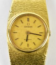 OMEGA; a lady's vintage 18ct yellow gold wristwatch with textured integral bracelet, length approx