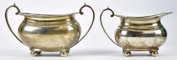 HARRISON BROTHERS; a George V hallmarked silver milk jug and matching twin handled sugar bowl with