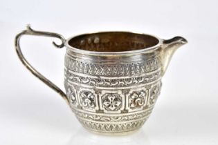 NATHAN & HAYES; a Victorian hallmarked silver cream jug with embossed stylised and floral