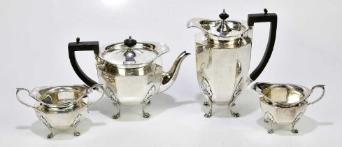 ROBERTS & BELK; a George V hallmarked silver four piece tea service with panelled decoration on