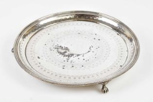 A M JACOBS; a Victorian hallmarked silver salver with cast beaded rim outside chased decoration,