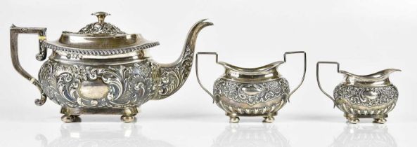 X JOSEPH GLOSTER; an Edward VII hallmarked silver three piece tea service, with repousse
