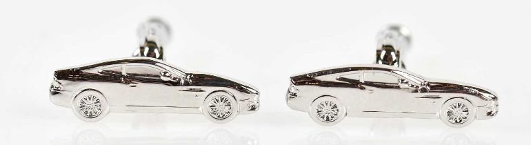 ASTON MARTIN; a pair of Anthony Holt designed silver cufflinks depicting the profile of the famous