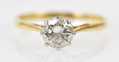 An 18ct yellow gold platinum tipped diamond solitaire ring, the round brilliant cut eight claw set