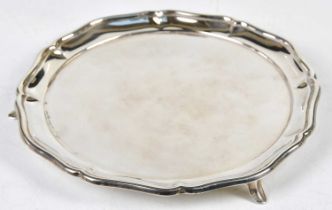 OLLIVANT & BOTSFORD; a George V hallmarked silver salver of plain circular form raised on three