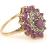 A 9ct gold ruby and white stone cluster ring, the central claw set marquise cut ruby surrounded by a