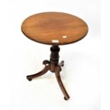 A 19th century circular tilt-top side table on a gun barrel turned column and outswept tripod