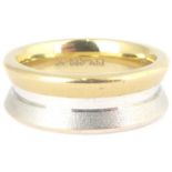 A 14ct gold contemporary ring with flanged sides, in two-tone yellow and white textured gold, with a