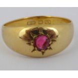 A 22ct gold ring with a small cut ruby in a star mount, size O, approx. 3.3g.