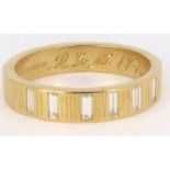 An 18ct gold half eternity ring, the Gypsy set seven vertical baguettes approx. 0.05ct each, total