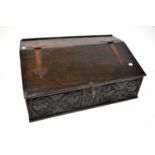 A 17th century (possibly later) oak Bible box with lift-up lid, carved floral and foliate decoration