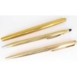 Three gold plated pens comprising a Parker ballpoint, a Parker fountain pen and a Cross ballpoint