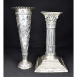 An Edwardian short single candlestick in the form of a Corinthian column, on stepped square weighted