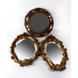 Three various wall mirrors comprising two with gilded Rococo oval frames, with acanthus leaf and