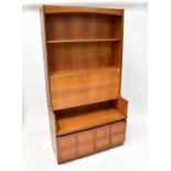 NATHAN; a 1960s retro teak bureau, arched pediment above two open shelves, fall front with fitted