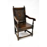A 17th century and later Wainscot type open armchair with corner finials to the top, panel back
