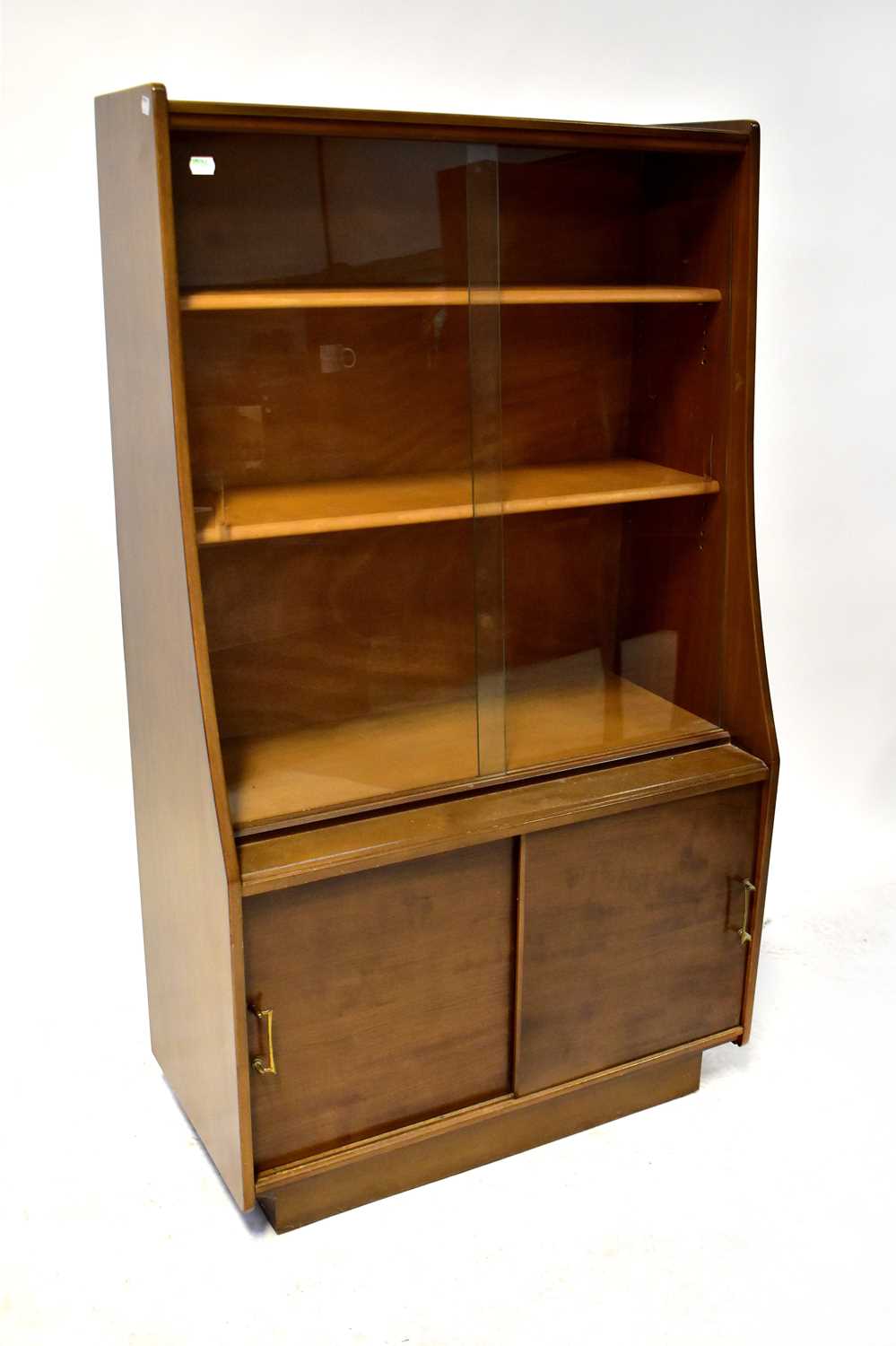 WELTERS of WHICKHAM; a 1960s retro teak bookcase, the upper section with pair of angled glazed