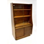 WELTERS of WHICKHAM; a 1960s retro teak bookcase, the upper section with pair of angled glazed