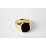 A 9ct yellow gold signet ring set with central black onyx, size O 1/2, approx. 5.2g.