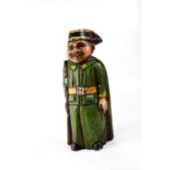 A novelty carved wooden wine bottle holder in the form of a moustachioed soldier, height 42cm.