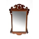 A 19th century mahogany fretwork mirror with rectangular mirror plate and fleur-de-lis motif to
