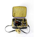 A case containing cameras and accessories to include an Olympus-Pen EE-2, an Exakta RTL 1000, an