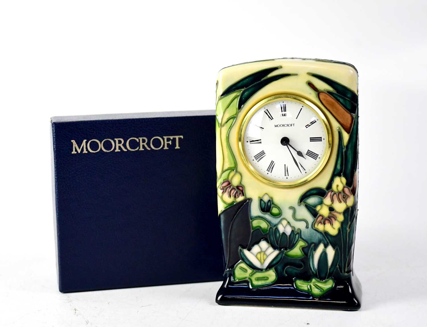 MOORCROFT; a mantel clock with green and blue drip glaze, tube lined 'Water Lilies and Bulrush'