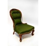A 19th century Victorian walnut balloon back nursing chair with green upholstered button back and