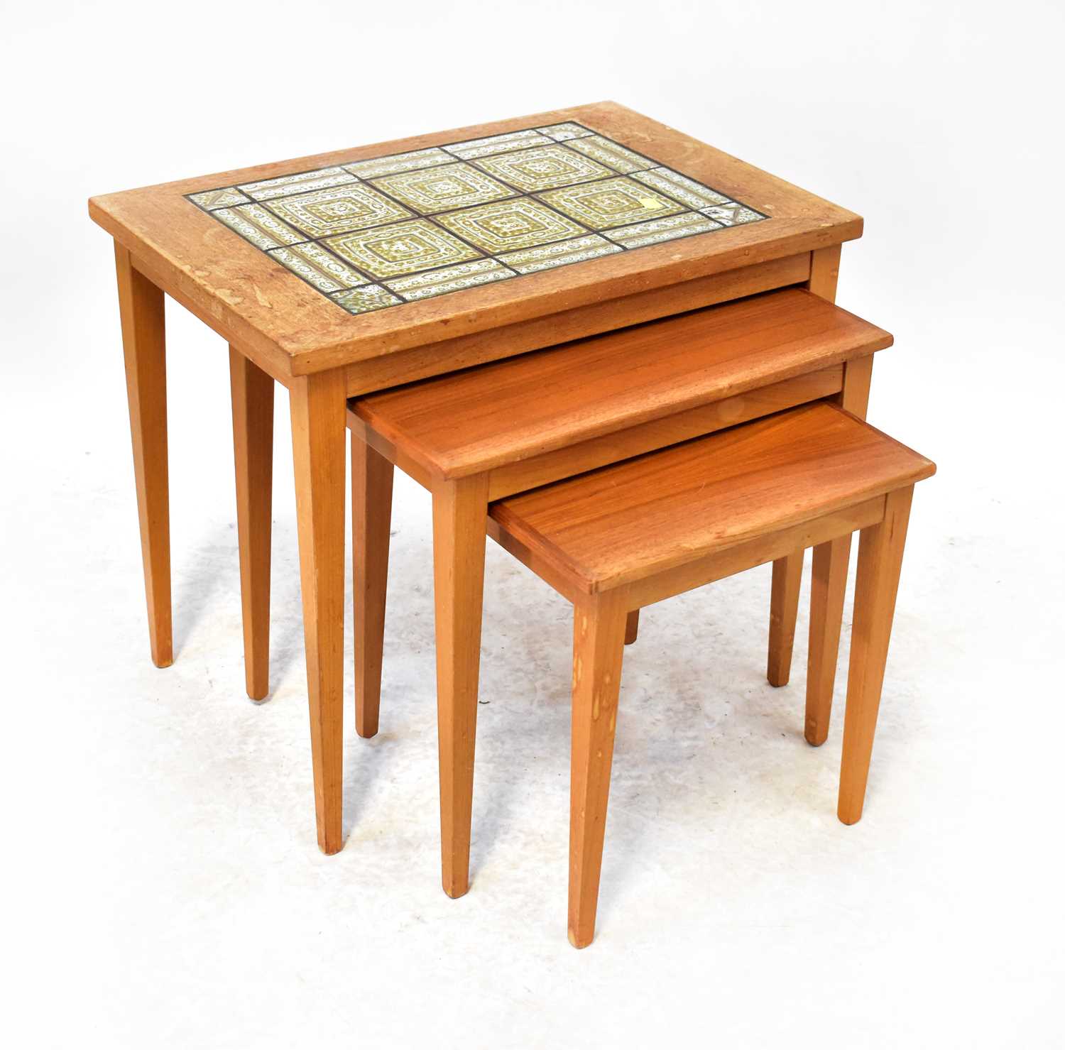 KVALITET; a c.1970s nest of three Danish teak tables, height of largest 51cm, length 41cm, height of