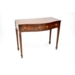 A mahogany reproduction side table with bow front and two drawers with lion mask hoop handles, on