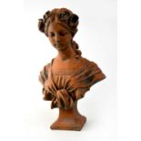 A terracotta bust of a young maiden with flowers in her hair, indistinctly signed verso and raised